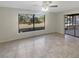 Bright open living space showcasing neutral paint, large windows, recessed lighting, and tile flooring at 8379 Begonia St, Spring Hill, FL 34608