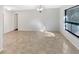 Bright living room with tile flooring, ceiling lights, and a large window letting in natural light at 8379 Begonia St, Spring Hill, FL 34608