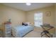 Bedroom with blue bedsheets, desk and keyboard at 10917 Brickside Ct, Riverview, FL 33579