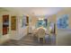 Bright dining area featuring sliding glass doors to the backyard and wood-look floors at 10917 Brickside Ct, Riverview, FL 33579