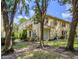 A sun-lit angle showcases the lush backyard, with a patio and well-maintained lawn at 10917 Brickside Ct, Riverview, FL 33579