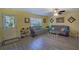 Inviting living room with neutral paint, ceiling fan, and laminate flooring at 10917 Brickside Ct, Riverview, FL 33579
