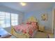 Cozy main bedroom with a double-size bed, side tables and a window at 10917 Brickside Ct, Riverview, FL 33579