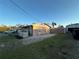 Rear view of property with a well-manicured lawn and detached garage at 2105 18Th W Ave, Bradenton, FL 34205