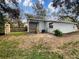 Rear exterior of home with a partially fenced yard, patio area, and shed for added storage at 2117 W Paris St, Tampa, FL 33604