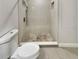 Updated bathroom featuring a tiled shower with modern fixtures and a stylish mosaic floor at 2117 W Paris St, Tampa, FL 33604