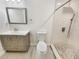 Modern bathroom featuring new vanity, toilet, and tiled walk-in shower at 2117 W Paris St, Tampa, FL 33604