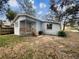 Cozy single-story home featuring a quaint front porch and natural landscaping at 2117 W Paris St, Tampa, FL 33604
