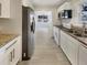 Modern kitchen with stainless steel appliances, granite countertops, and ample cabinet space at 2117 W Paris St, Tampa, FL 33604