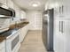 Updated kitchen featuring granite countertops, stainless steel appliances, and white cabinets at 2117 W Paris St, Tampa, FL 33604