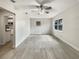 Bright living room featuring new flooring, paint, and a modern ceiling fan at 2117 W Paris St, Tampa, FL 33604
