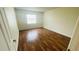 Bright bedroom featuring wood floors and a sun-filled window offering natural light at 2850 Somerset Park Dr # 201, Tampa, FL 33613