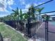 View of community pool area, featuring lush tropical greenery and secure fencing for resident enjoyment at 2850 Somerset Park Dr # 201, Tampa, FL 33613