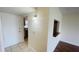 Hallway leading to the kitchen with a granite breakfast bar overlooking the living area at 2850 Somerset Park Dr # 201, Tampa, FL 33613