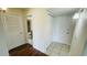 Hallway with tile flooring and a view into the bathroom showcasing the toilet and vanity at 2850 Somerset Park Dr # 201, Tampa, FL 33613