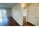 Living room area with sliding glass doors to the patio and view into the hallway at 2850 Somerset Park Dr # 201, Tampa, FL 33613