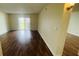 Open living room with wood flooring and sliding glass doors to a balcony overlooking the outdoors at 2850 Somerset Park Dr # 201, Tampa, FL 33613
