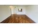 Bright living room featuring stylish wood flooring and an open view to the adjacent kitchen at 2850 Somerset Park Dr # 201, Tampa, FL 33613