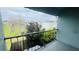 Patio view of landscape with a wooden fence in the foreground and buildings in the background at 2850 Somerset Park Dr # 201, Tampa, FL 33613