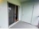 Condo patio features a sliding glass door, an exterior door, and concrete flooring at 2850 Somerset Park Dr # 201, Tampa, FL 33613