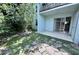 View of outdoor patio surrounded by natural landscaping and a large tree at 2856 Somerset Park Dr # 102, Tampa, FL 33613