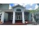 Community center with a red brick roof, white pillars, and well-maintained landscaping at 2856 Somerset Park Dr # 102, Tampa, FL 33613