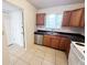 Well lit kitchen with stainless steel appliances and wooden cabinets at 2856 Somerset Park Dr # 102, Tampa, FL 33613