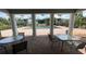 View of the pool and neighborhood from beneath stately white columns, with outdoor seating nearby at 2856 Somerset Park Dr # 102, Tampa, FL 33613