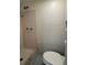 Bathroom with a shower, toilet, and tiled walls at 4325 Newbury Dr, New Port Richey, FL 34652