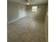 Bedroom features include tile flooring, a ceiling fan, closet, and natural light at 4325 Newbury Dr, New Port Richey, FL 34652
