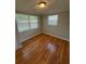 Bedroom featuring hardwood floors, natural light, and neutral paint at 4325 Newbury Dr, New Port Richey, FL 34652