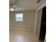 Bright bedroom featuring tiled flooring, ceiling fan, and a window letting in natural light at 4325 Newbury Dr, New Port Richey, FL 34652