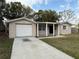 The front exterior shows a single-story home with a driveway leading to an attached garage and covered front entry at 4325 Newbury Dr, New Port Richey, FL 34652