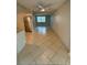 Open kitchen with stainless steel refrigerator, tile flooring, and seamless access to the living area at 4325 Newbury Dr, New Port Richey, FL 34652