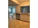 Kitchen view with granite countertops, stainless steel dishwasher, and tile flooring at 4325 Newbury Dr, New Port Richey, FL 34652