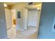 Hallway featuring tile flooring, utility panel, and access to the bathroom and bedrooms at 2860 Somerset Park Dr # 203, Tampa, FL 33613