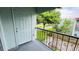 Outdoor patio area with a pleasant view of landscaping and a nearby street at 2860 Somerset Park Dr # 203, Tampa, FL 33613