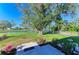 Backyard featuring luscious green landscaping, waterfront views, and direct access to the water at 408 43Rd Street W Blvd, Palmetto, FL 34221