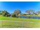 Scenic backyard with a tranquil canal view, lush green lawn, and secure chain-link fencing at 408 43Rd Street W Blvd, Palmetto, FL 34221