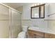 Well-lit bathroom with a glass shower door and a wood vanity cabinet with a marble countertop at 408 43Rd Street W Blvd, Palmetto, FL 34221