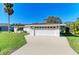 Single-story home featuring a well-manicured lawn, a two-car garage, and a freshly painted exterior at 408 43Rd Street W Blvd, Palmetto, FL 34221