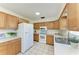 Bright kitchen features white appliances, wood cabinets and a stainless steel sink at 408 43Rd Street W Blvd, Palmetto, FL 34221