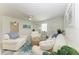 Spacious living room featuring white sofas, a cozy rug, ceiling fan and tasteful nautical decor at 408 43Rd Street W Blvd, Palmetto, FL 34221