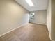 Cozy bedroom featuring a large window, neutral carpet, and ample closet space at 1038 Rolling Oaks Ave, Tarpon Springs, FL 34689