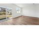 Bedroom with wood-look floors, a sliding glass door, and a view of the community playground at 11840 Sylvia St, Dade City, FL 33525