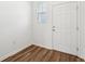 Bright entryway featuring wood-look flooring, white walls, and a window near the white front door at 11840 Sylvia St, Dade City, FL 33525