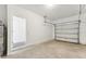 Clean garage with a view of the garage door and concrete floors, ready for customization and use at 11840 Sylvia St, Dade City, FL 33525