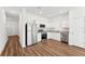 Well-lit kitchen featuring stainless steel appliances, granite countertops, and wood-look flooring at 11840 Sylvia St, Dade City, FL 33525