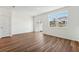 Living room featuring wood-look floors, natural light, and a sliding door to the backyard at 11840 Sylvia St, Dade City, FL 33525