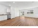 Bright and airy living room featuring wood-look flooring, white walls, and natural light at 11840 Sylvia St, Dade City, FL 33525